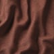 Close-up of soft, textured red fabric; intricate weave visible, showcasing quality.