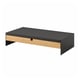A black and bamboo monitor stand with a storage drawer for a neat workspace.