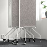 Double-sided mobile whiteboard with casters and storage shelf. Ideal for writing and pinning notes.
