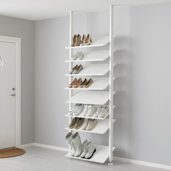 White ELVARLI shoe rack, storing various footwear on adjustable shelves against a gray wall.