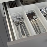 Silverware organizer drawer with forks, knives, and spoons in compartments. Part of ENHET kitchen series.