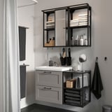 Modern grey bathroom with ENHET vanity, mirror, and shower.