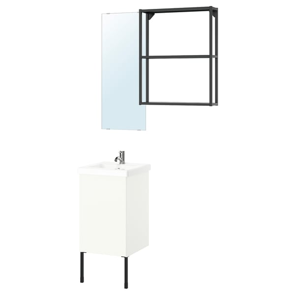 A modern bathroom setup: white cabinet with black legs, black-framed mirror, sleek sink with chrome tap.