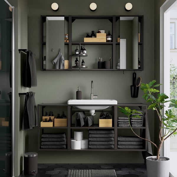 Modern dark green bathroom with ENHET open storage, mirrored cabinets, sink, and plant.
