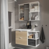 Modern bathroom with light wood and white ENHET vanity, mirrored cabinet, and accessories.