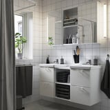 ENHET white vanity with mirrors, 2 sinks, open shelves & folded towels. Symmetrical, modern, minimalist design.
