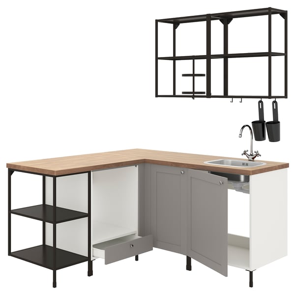 Modern kitchen setup: grey cabinets, oak top, stainless steel sink, black shelves.