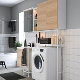 White ENHET laundry/bathroom combo with washing machine, shelves, and modern wooden/metallic design.