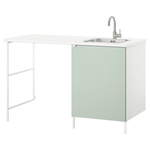 A white ENHET utility station with a green cabinet, sink, and stainless steel tap. It includes a countertop and storage.