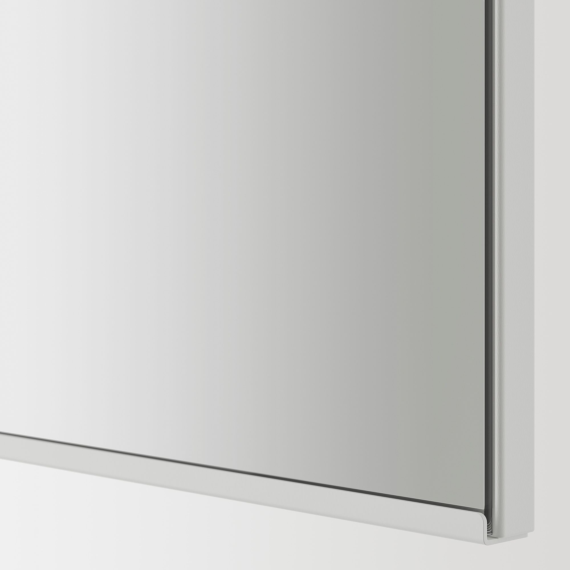 Clear, high-quality mirror with sleek, silver frame, reflecting light, perfect for bathroom use.