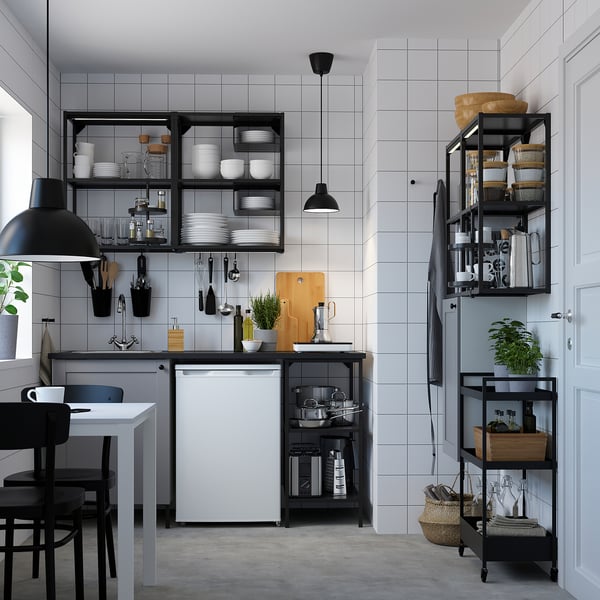 Modern kitchen with ENHET series: grey units, open and closed storage, white appliances, black chairs, plants, and pendant lamps.
