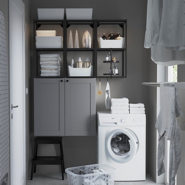Laundry room with ENHET cabinets, white washer, towels, dryer, black stool, sink