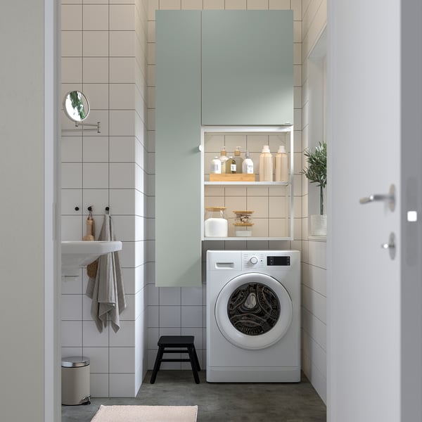 Modern laundry with ENHET wardrobe, washing machine, and organized accessories.