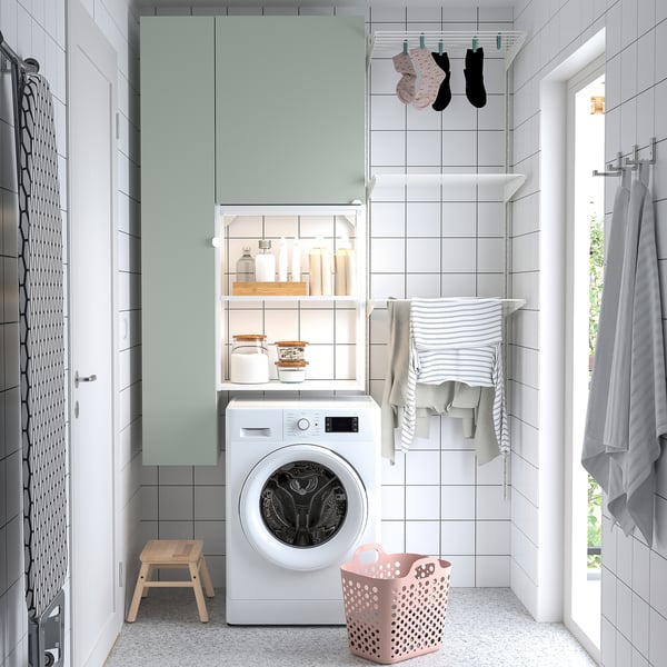 Modern laundry room with ENHET storage, washing machine, clothes rack, and accessories.