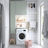 Modern laundry room with ENHET storage, washing machine, clothes rack, and accessories.
