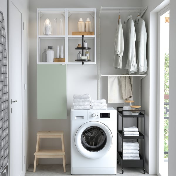 Modern laundry setup with ENHET storage. Glass doors, washing machine, stool.