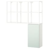 An ENHET storage unit in white and pale grey-green, with a mix of open and closed shelves for versatile storage.