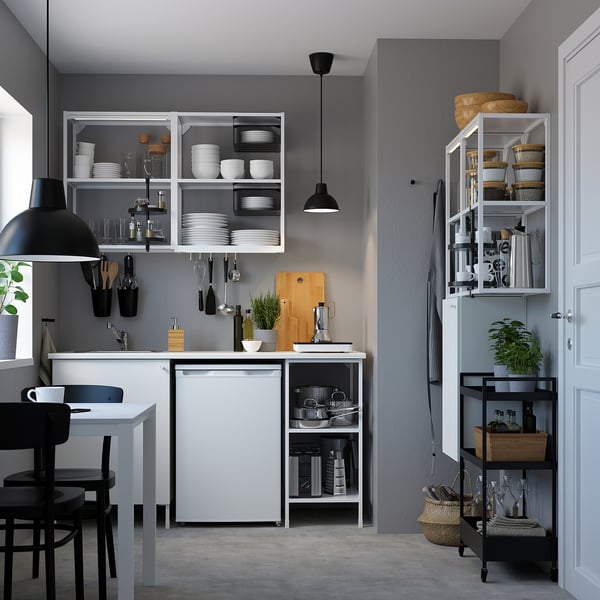 Modern kitchen with ENHET storage, glassware, dishes, and dining table.