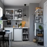 Modern kitchen with ENHET storage, glassware, dishes, and dining table.