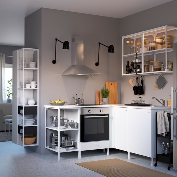 Contemporary white kitchen setup with open shelves, stainless steel appliances, and black accents.