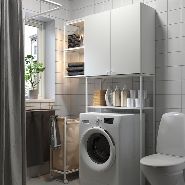 Modern laundry room with ENHET cabinets, washing machine, toilet, and storage.
