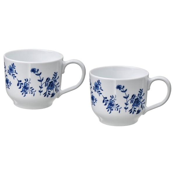Two white porcelain mugs with blue floral designs, round shape, and handles. Ideal for tea or coffee.