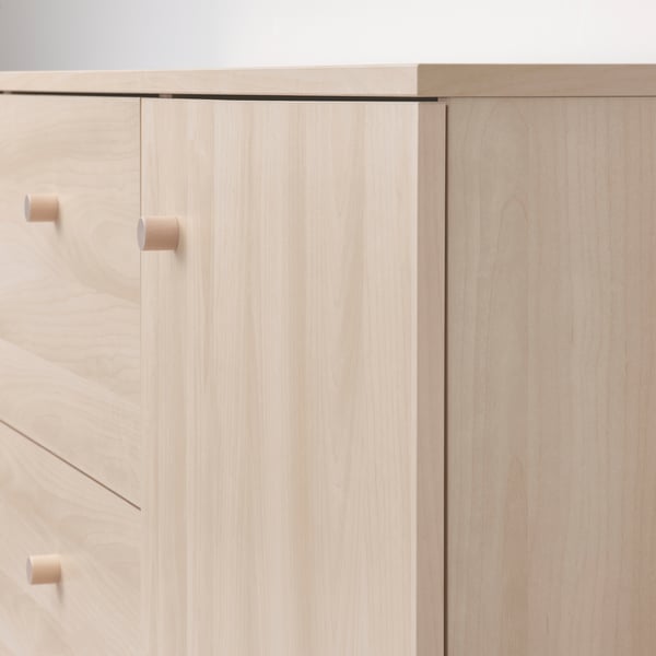 Modern, sleek wooden cabinet with light birch finish and minimalistic design.