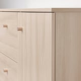 Modern, sleek wooden cabinet with light birch finish and minimalistic design.