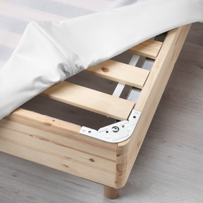 Wooden bed frame with support bars and metal brackets, stabilizing mattress placement.