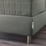 Close-up of high-quality green sofa with sleek metal legs and detailed stitching.