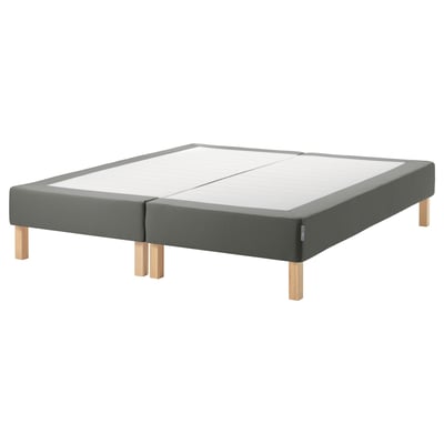Dark grey upholstered bed base with wooden legs.