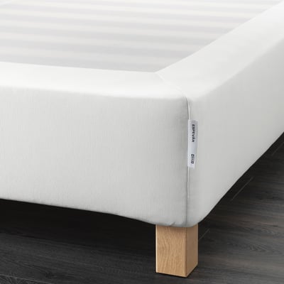 A white mattress base with wooden legs by ikea. It raises the bed, supports the mattress, and allows airflow.