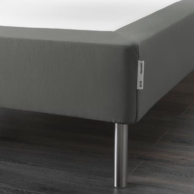 A corner of a grey ESPEVÄR mattress base with stainless steel legs, raising the bed height for easier access.