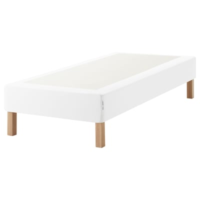 A white ESPEVÄR bed base with wooden legs. It supports mattresses and raises bed height.