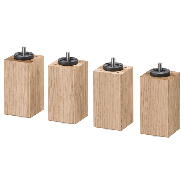 Four light brown wooden blocks with black circular attachments on top, arranged in a row, isolated on white.