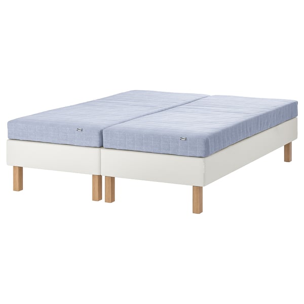 The ESPEVÄR/VADSÖ mattress set. It two light blue mattresses and a white base with wooden legs.