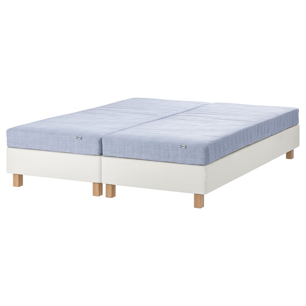 White & blue split mattress on base, light wood feet, IKEA.