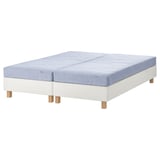 White & blue split mattress on base, light wood feet, IKEA.