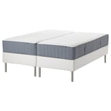 Two white mattresses on a white base with metal legs, blue trim.