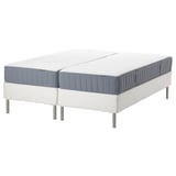 Two ESPEVÄR/VALEVÅG mattresses on a white bed base, grey and white in color, with stainless steel legs.