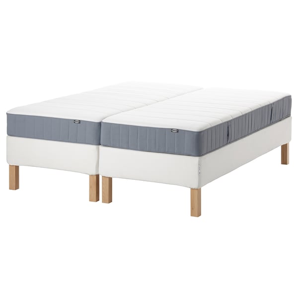 An ESPEVÄR/VESTERÖY bed in white with a blue-gray mattress, featuring wooden legs and a pocket sprung design.