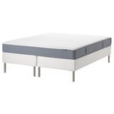 White and gray rolled mattress on white bed frame.