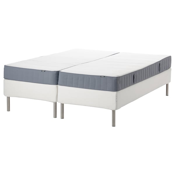 Two white split mattresses on a white and gray base with metal legs, ideal for adjustable sleeping surfaces.