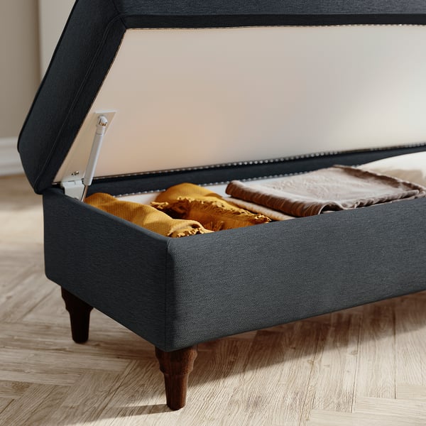 Grey storage bench with blankets