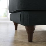 Dark gray upholstered footstool with wooden legs, stylish and comfortable.