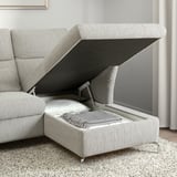 Modern sofa with adjustable headrests, providing comfort and versatile use; storage space underneath opens for extra items.