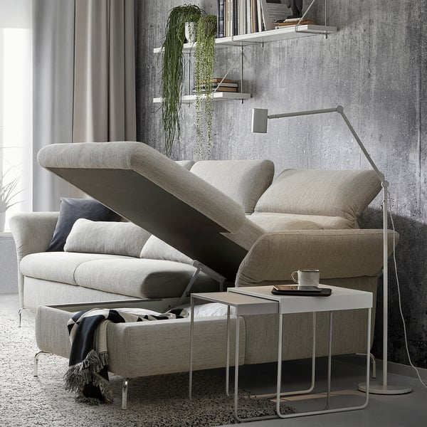 Modern light grey FAMMARP sofa with adjustable headrests and armrests, a side table with a mug, and a hanging plant.