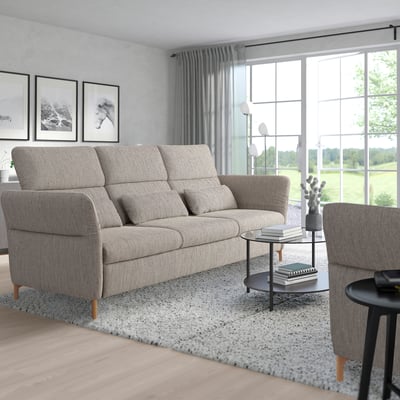 Modern living room with gray FAMMARP sofa, rug, table, and large windows.