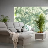 Modern living room with light gray FAMMARP sofa, green throw pillows, plants, and fruit bowl.