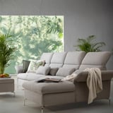Modern living room with light gray FAMMARP sofa, adjustable cushions, and large window with green leafy view.